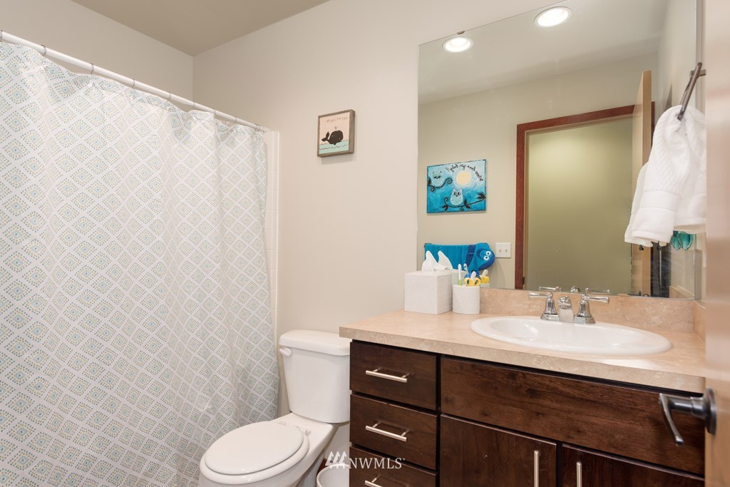 4821 Northeast Sunset Boulevard Renton, WA 98059 - Photo 9 of 12 a bathroom with a sink vanity mirror and toilet