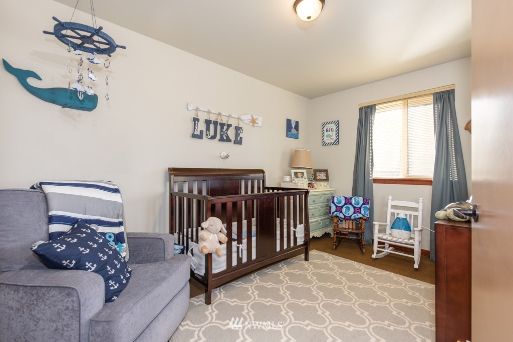 4821 Northeast Sunset Boulevard Renton, WA 98059 - Photo 10 of 12 a bedroom with furniture and a window