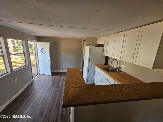 a view of a living room with furniture and a window