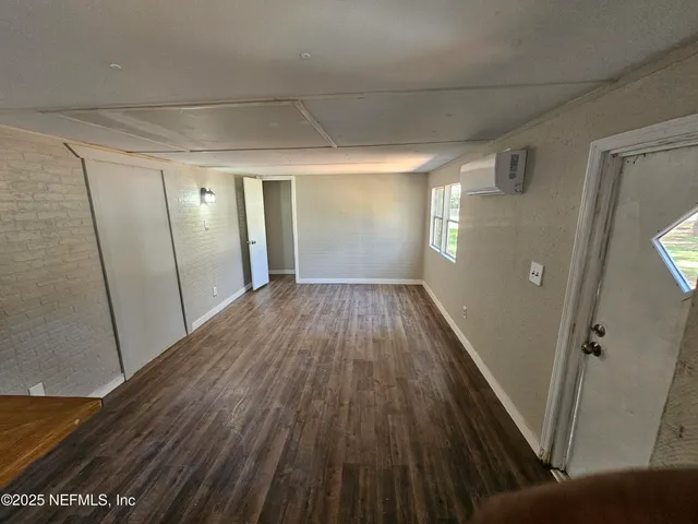 a view of a room with wooden floor and staircase