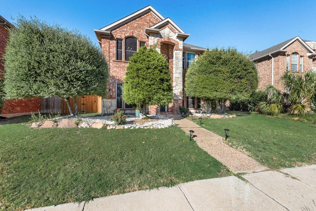 5404 Worley Drive The Colony, TX 75056 - Photo 1 of 30 a front view of a house with garden