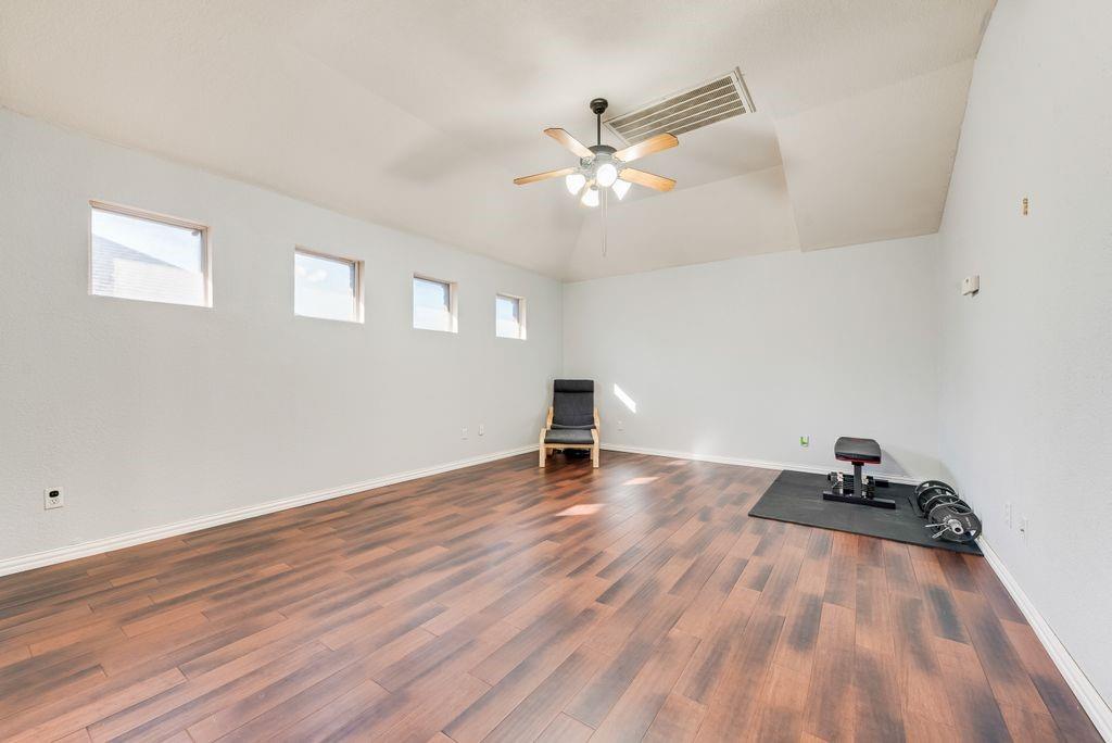 5404 Worley Drive The Colony, TX 75056 - Photo 15 of 30 a view of a room with wooden floor and fan
