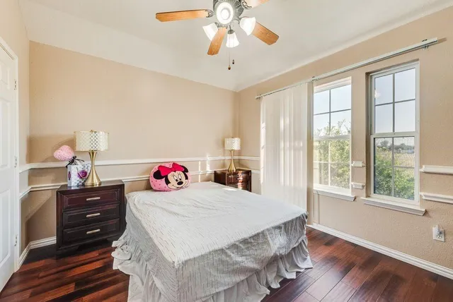 a view of a room with wooden floor and fan
