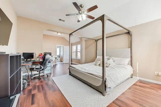 a bedroom with a bed dresser and a window