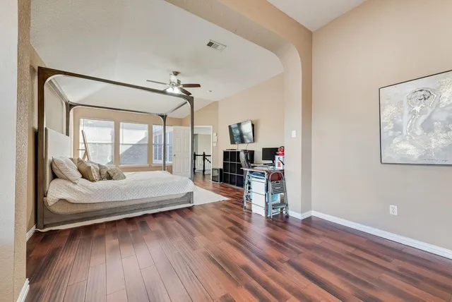 a bed room with a bed and a chair