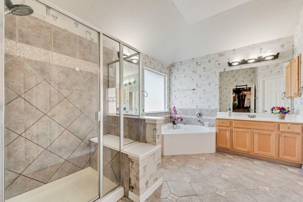 5404 Worley Drive The Colony, TX 75056 - Photo 23 of 30 a bathroom with a bathtub sink and mirror