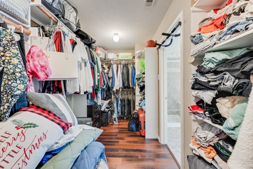 5404 Worley Drive The Colony, TX 75056 - Photo 25 of 30 a view of walk in closet with clothes and shoes