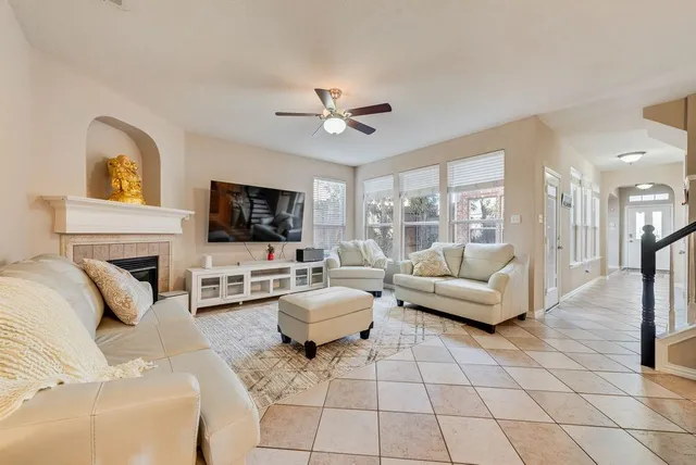 a living room with furniture a flat screen tv and a fireplace