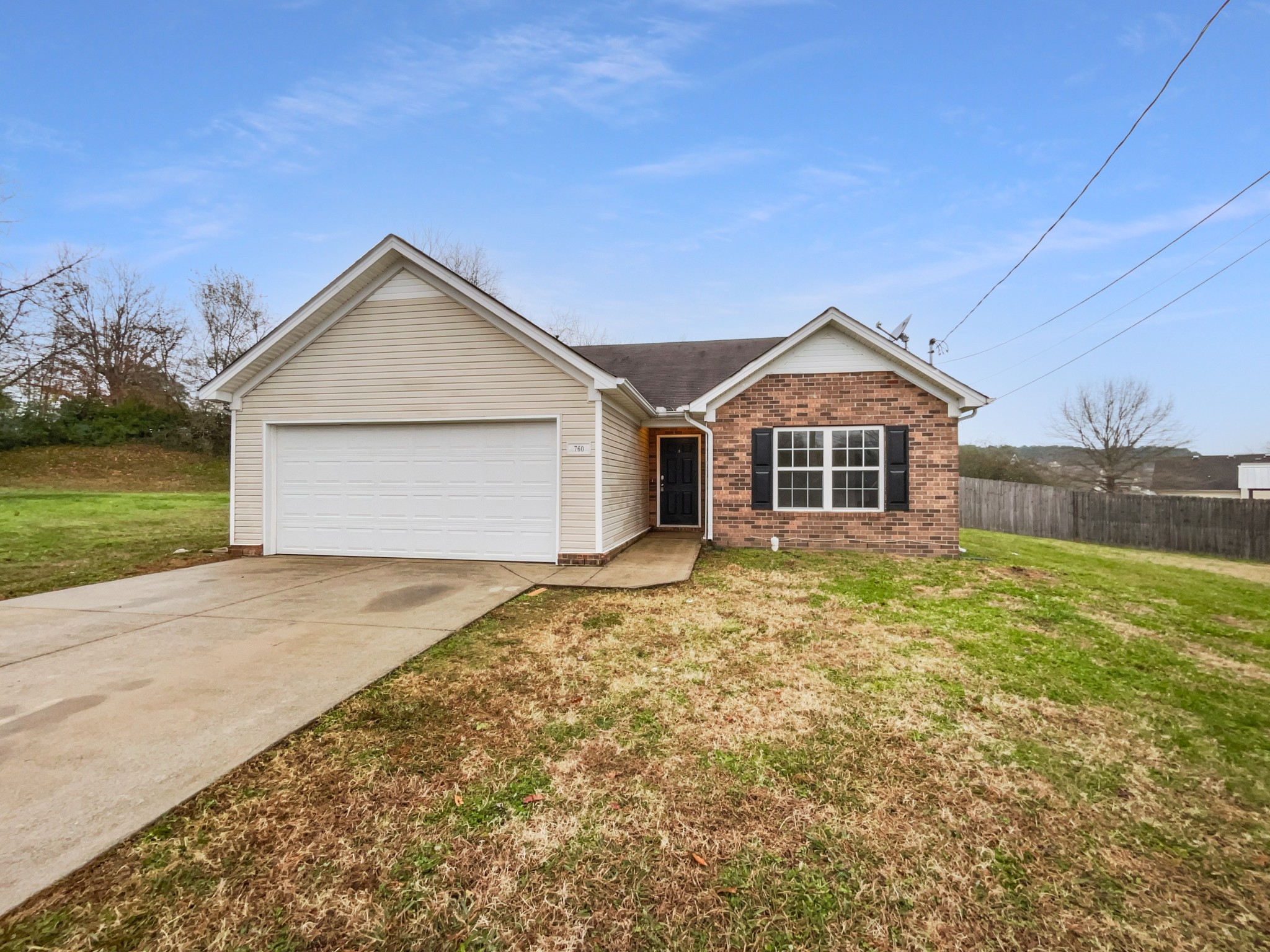 a view of a house with a yard and garage