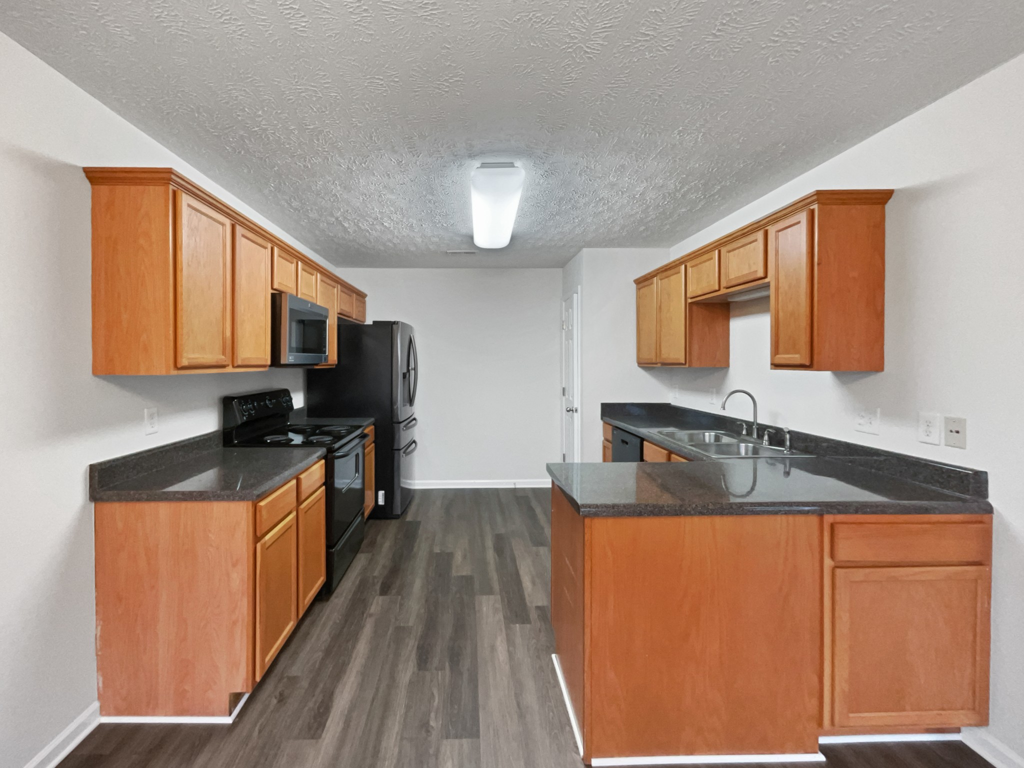 760 Autumn Ridge Lane Columbia, TN 38401 - Photo 5 of 19 a kitchen with granite countertop a sink stove and refrigerator