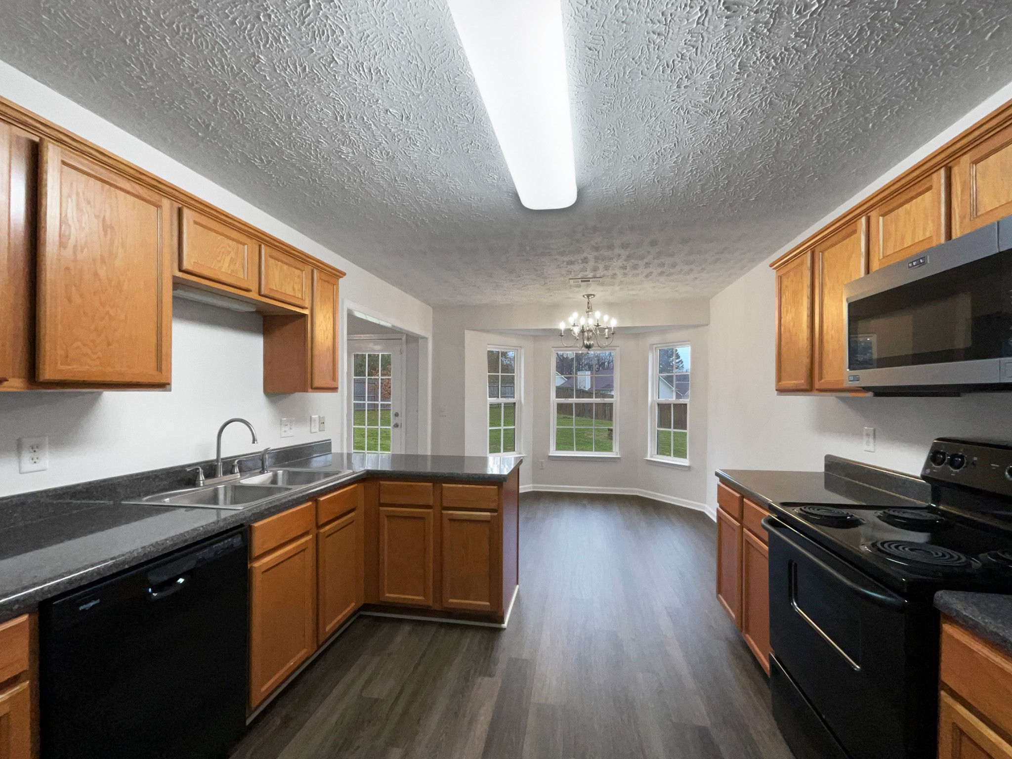 760 Autumn Ridge Lane Columbia, TN 38401 - Photo 6 of 19 a kitchen with stainless steel appliances a sink stove and wooden floor
