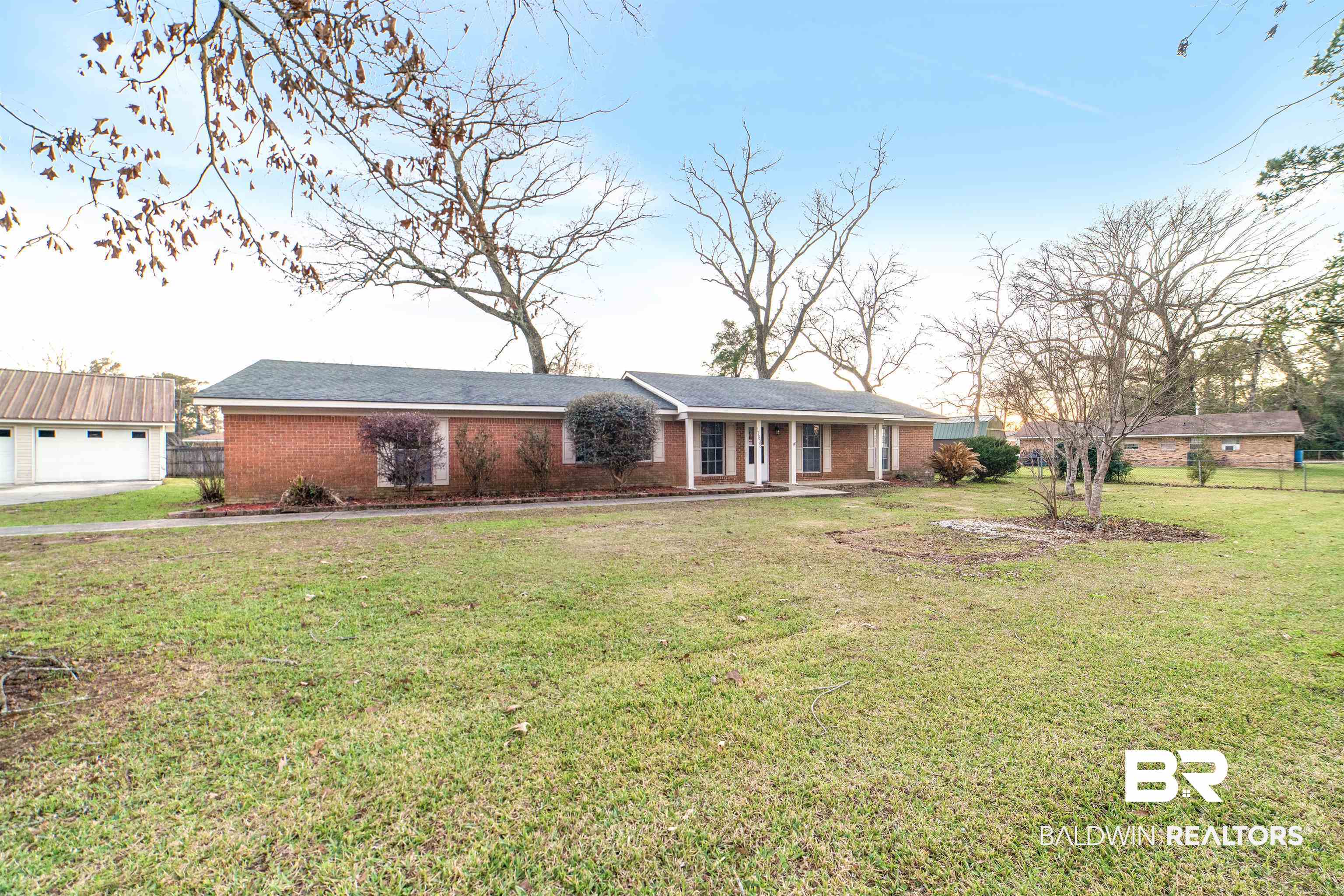 11833 Old Moffat Road Wilmer, AL 36587 - Photo 21 of 23 Ranch-style house with a front lawn, fence, and brick siding