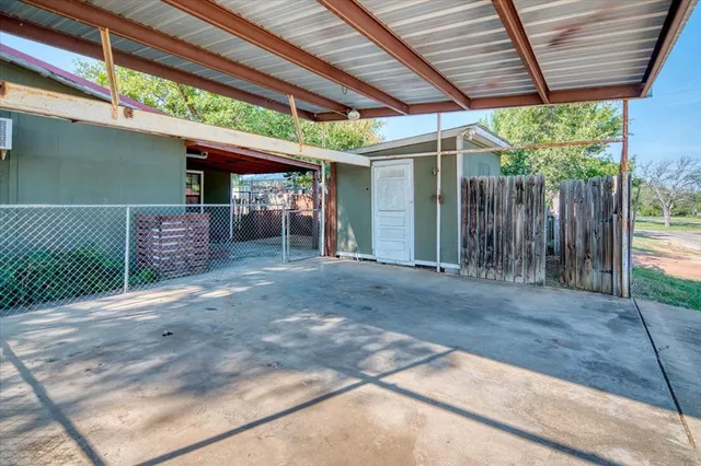 a view of back yard with wooden fence