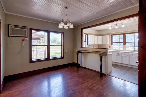 a view of a kitchen with a dishwasher cabinets and wooden floor