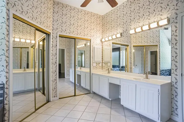 a spacious bathroom with a shower a sink and a mirror