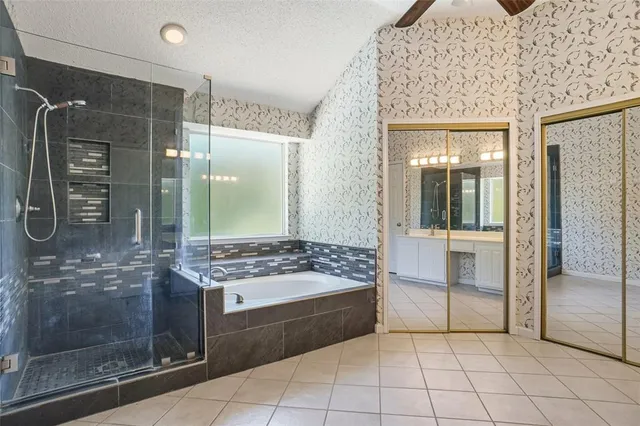 a bathroom with a tub shower and sink