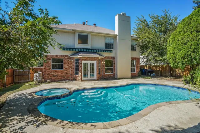 a view of a house with swimming pool and sitting area