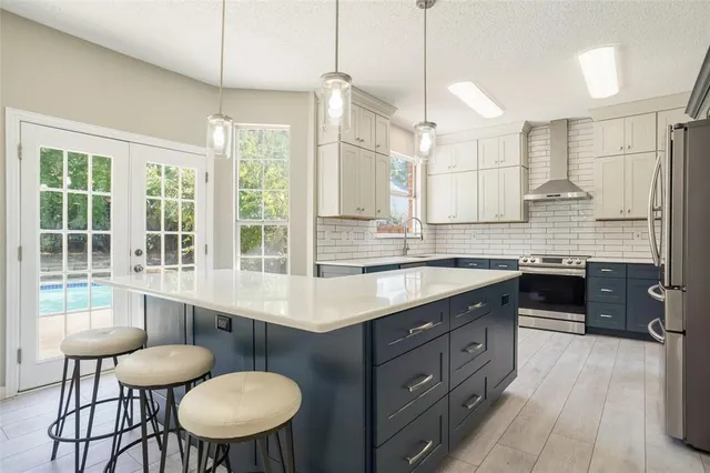 a kitchen with a table chairs stove and cabinets