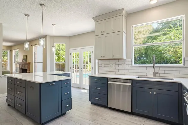 a kitchen with a sink window and cabinets
