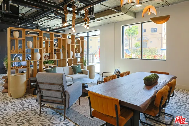 a living room with a large window and furniture