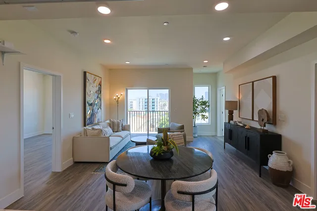 a living room with fireplace furniture and a wooden floor