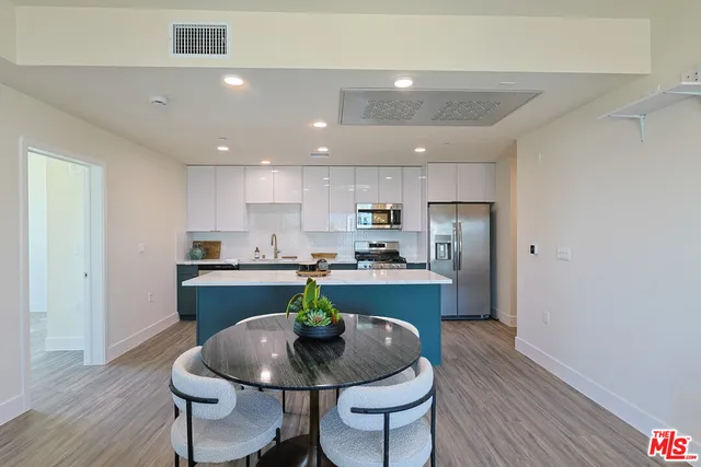 a kitchen with a table and chairs in it