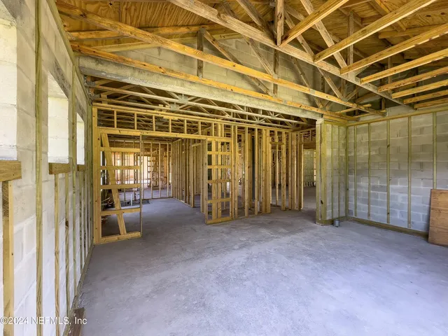 a view of a room with wooden floor and a window