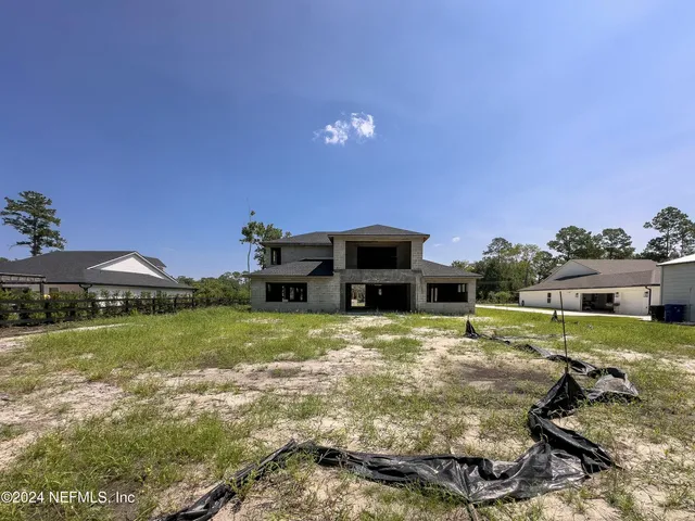 a black and white photo of a bench in a front