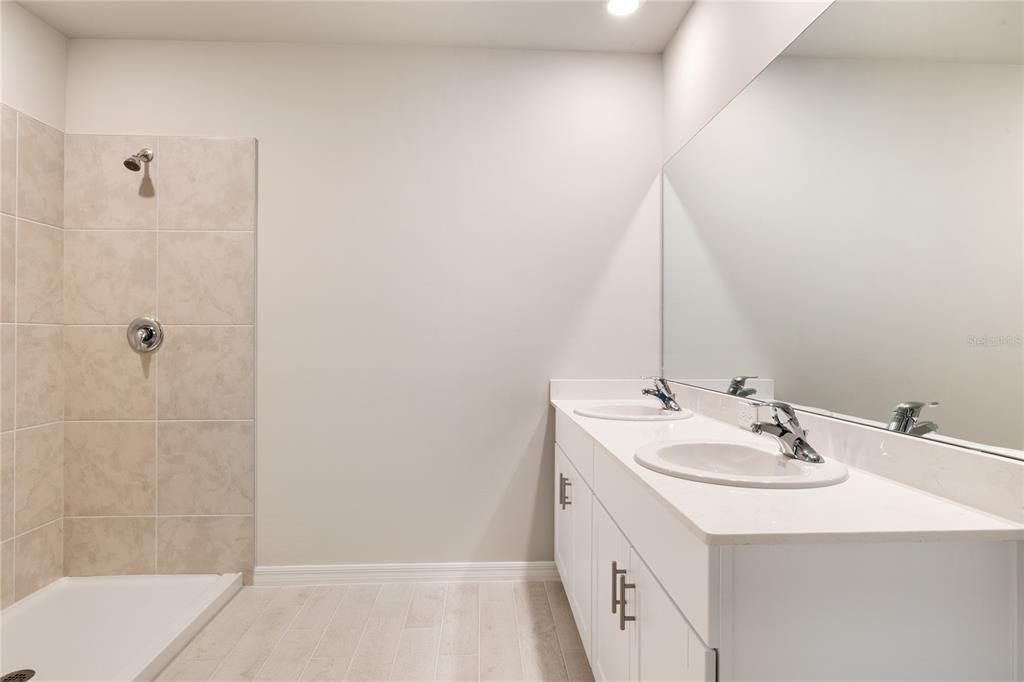 9504 Turtle Grass Circle Punta Gorda, FL 33950 - Photo 17 of 21 a bathroom with a sink a vanity and a mirror