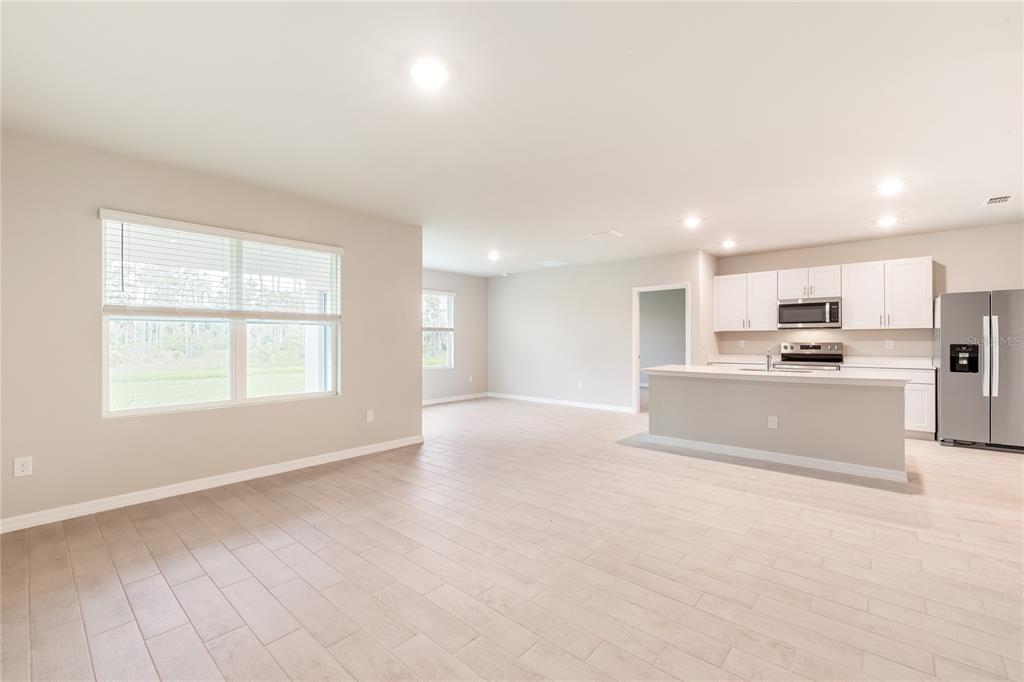 9504 Turtle Grass Circle Punta Gorda, FL 33950 - Photo 8 of 21 a large white kitchen with kitchen island a sink stainless steel appliances and cabinets