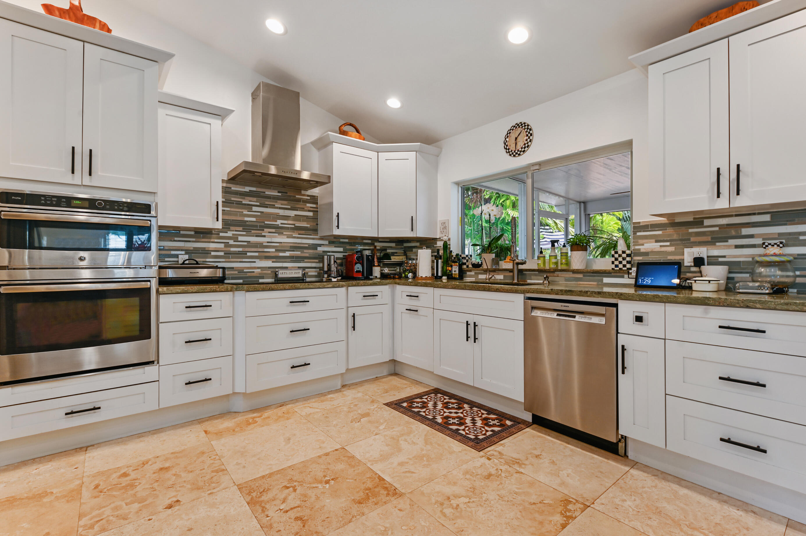 600 Mission Hill Road Boynton Beach, FL 33435 - Photo 13 of 42 a kitchen with stainless steel appliances kitchen island granite countertop a stove a sink and a microwave