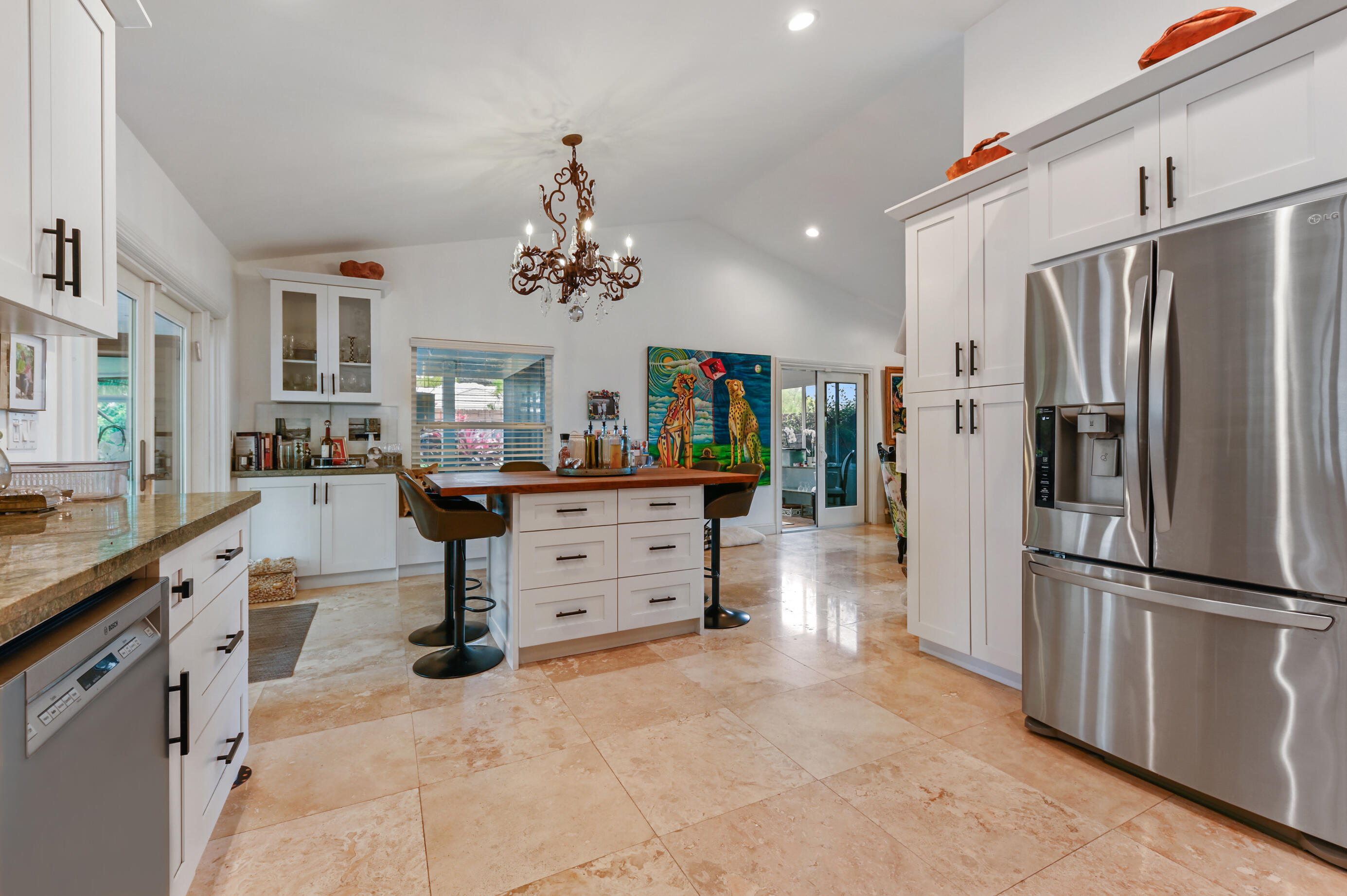 600 Mission Hill Road Boynton Beach, FL 33435 - Photo 14 of 42 a kitchen with stainless steel appliances kitchen island granite countertop a refrigerator and a stove top oven