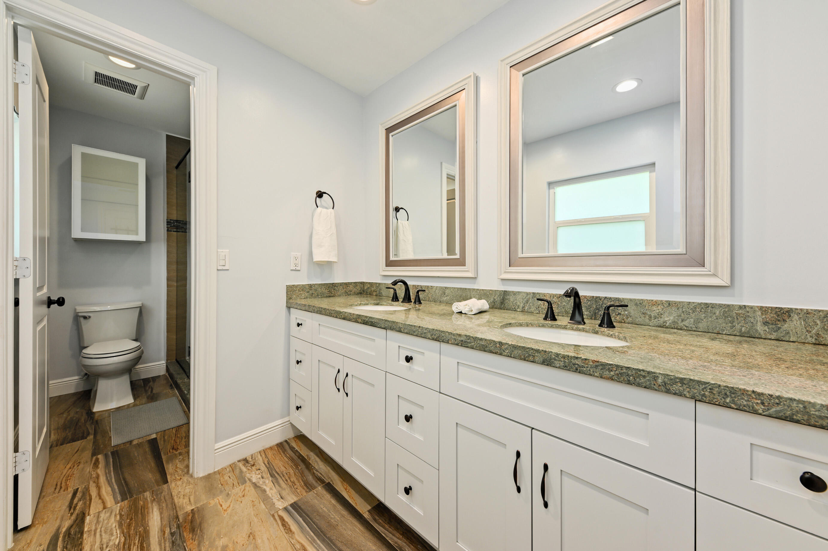 600 Mission Hill Road Boynton Beach, FL 33435 - Photo 17 of 42 a bathroom with a granite countertop sink mirror and toilet