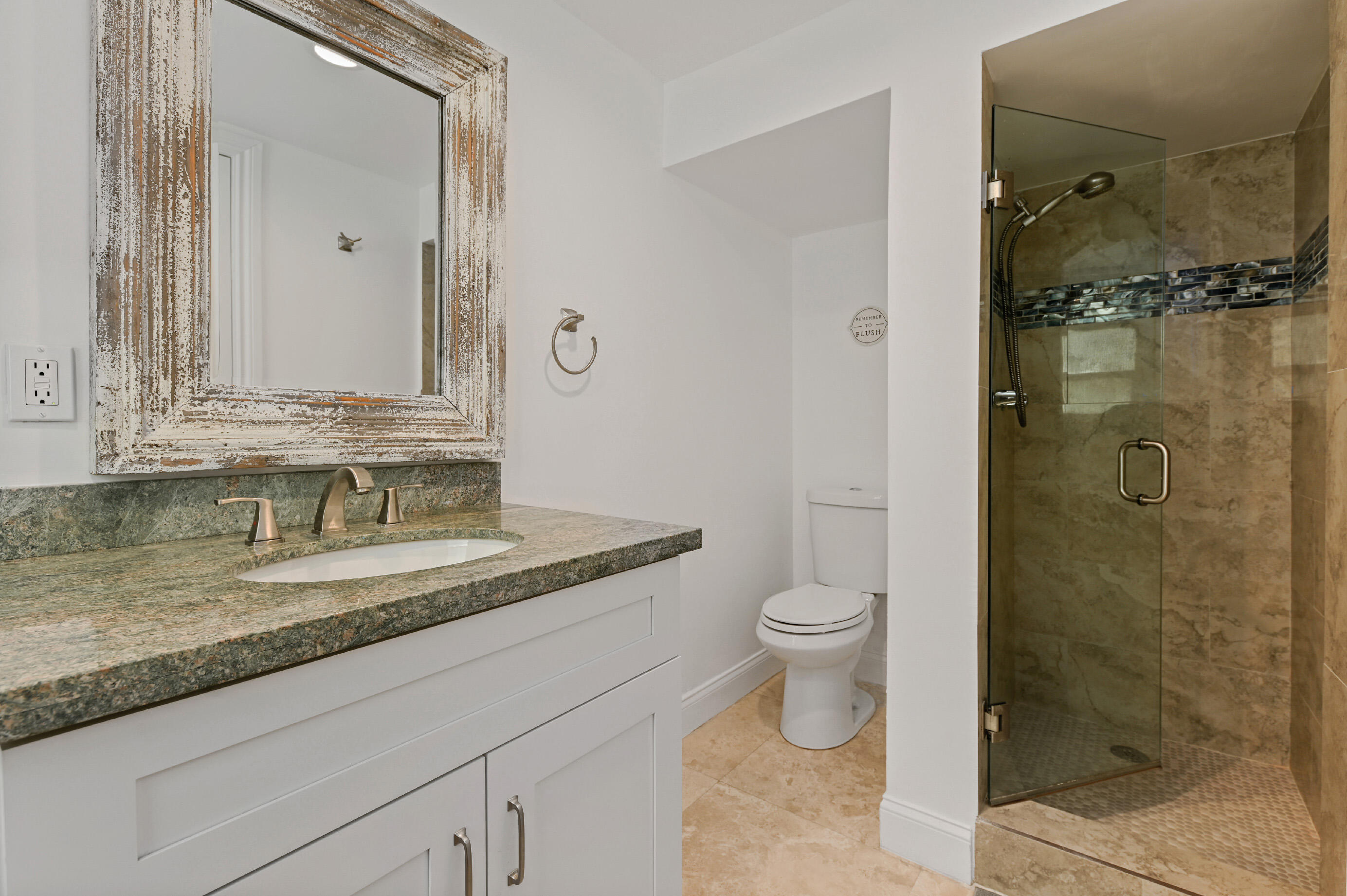 600 Mission Hill Road Boynton Beach, FL 33435 - Photo 18 of 42 a bathroom with a granite countertop sink a toilet and shower