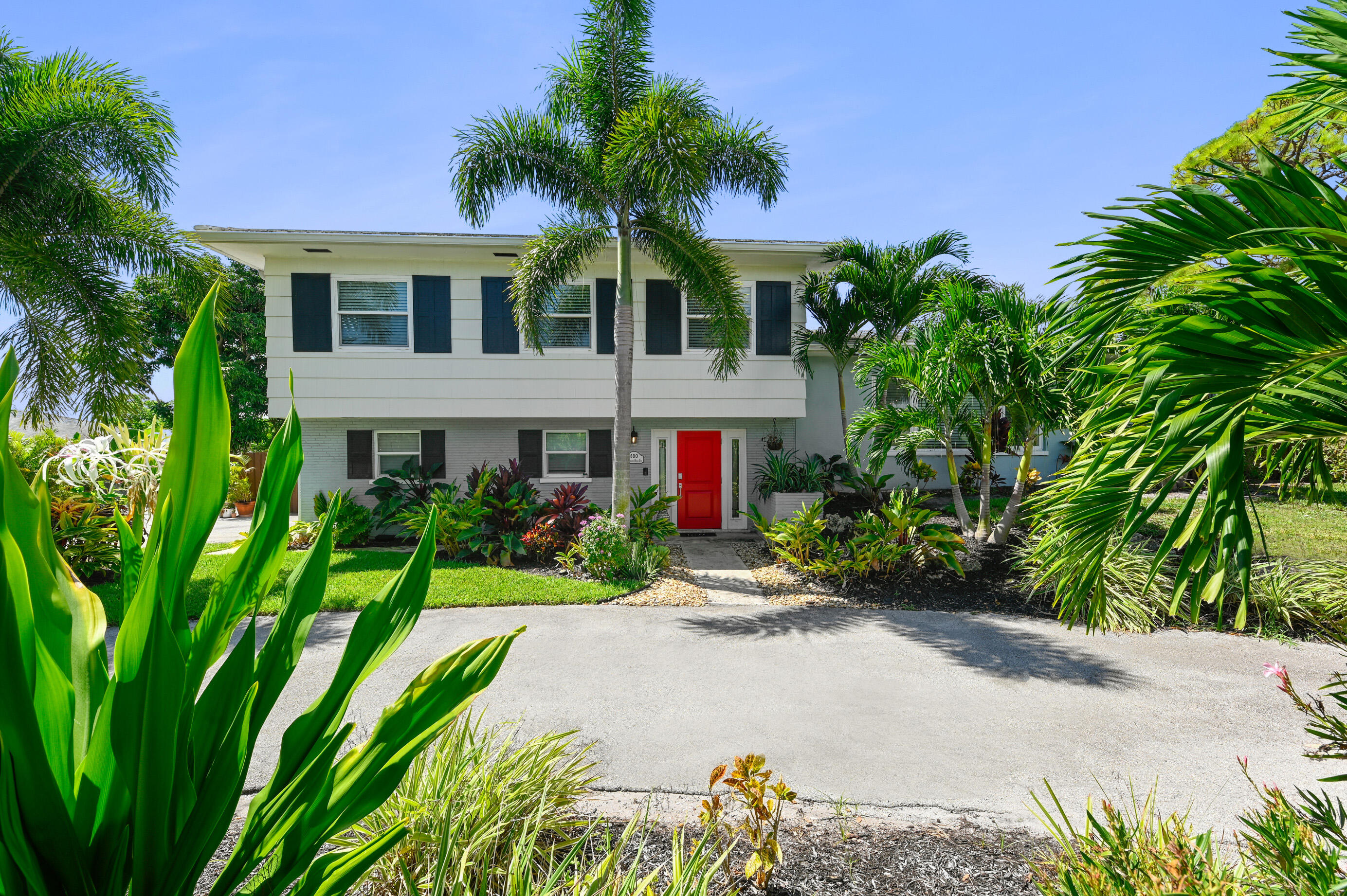 600 Mission Hill Road Boynton Beach, FL 33435 - Photo 2 of 42 a front view of a house with a yard and potted plants
