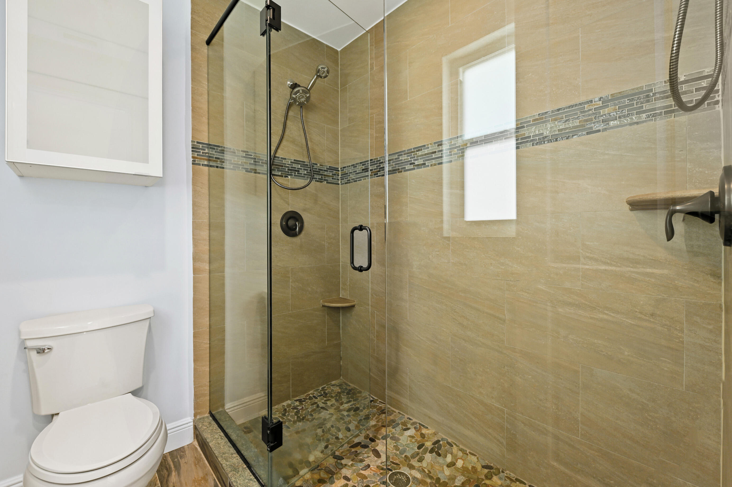 600 Mission Hill Road Boynton Beach, FL 33435 - Photo 21 of 42 a bathroom with a toilet and a shower