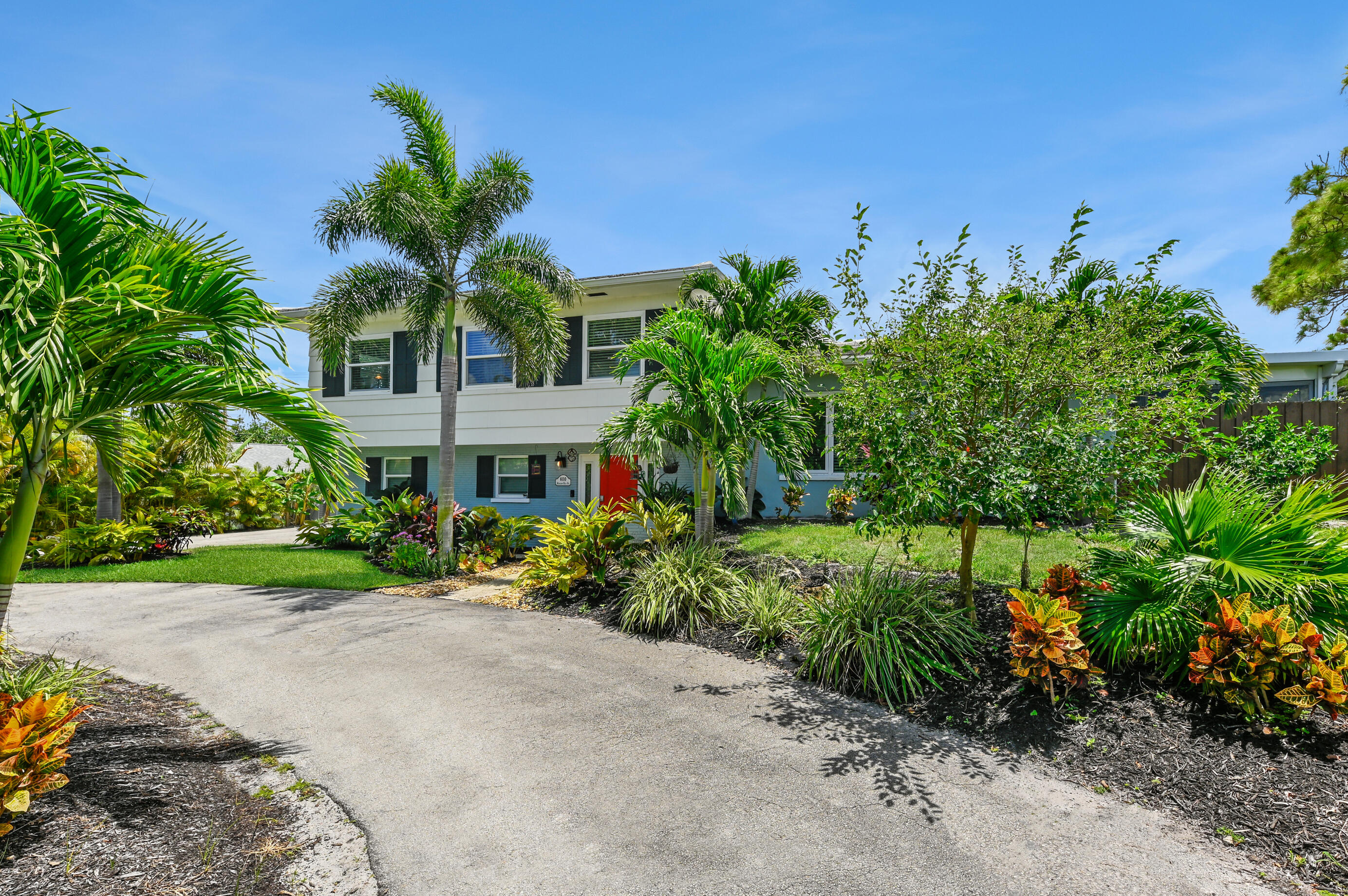 600 Mission Hill Road Boynton Beach, FL 33435 - Photo 3 of 42 a view of a garden with a building in front of it