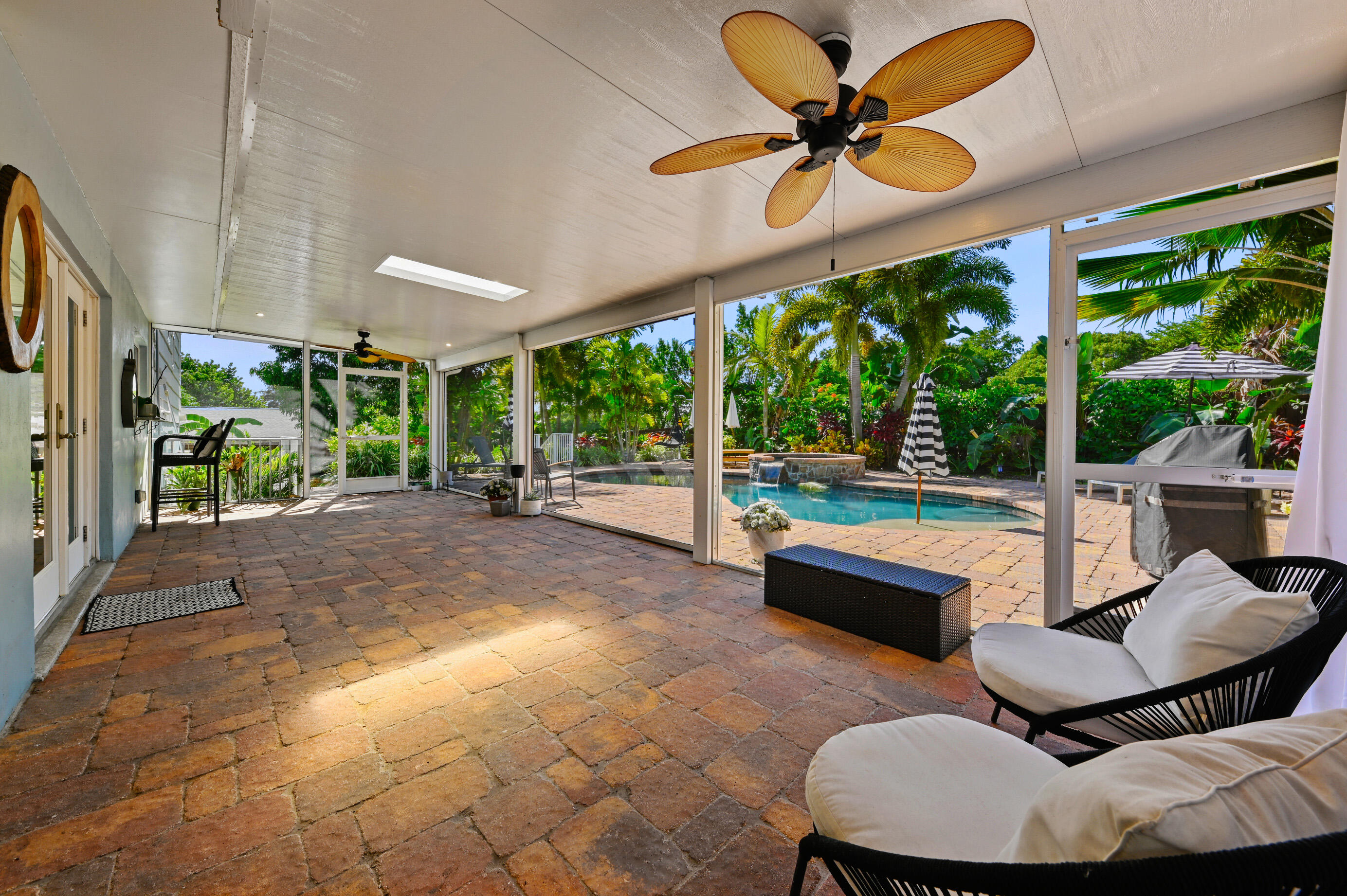 600 Mission Hill Road Boynton Beach, FL 33435 - Photo 34 of 42 a living room with patio furniture and a large window