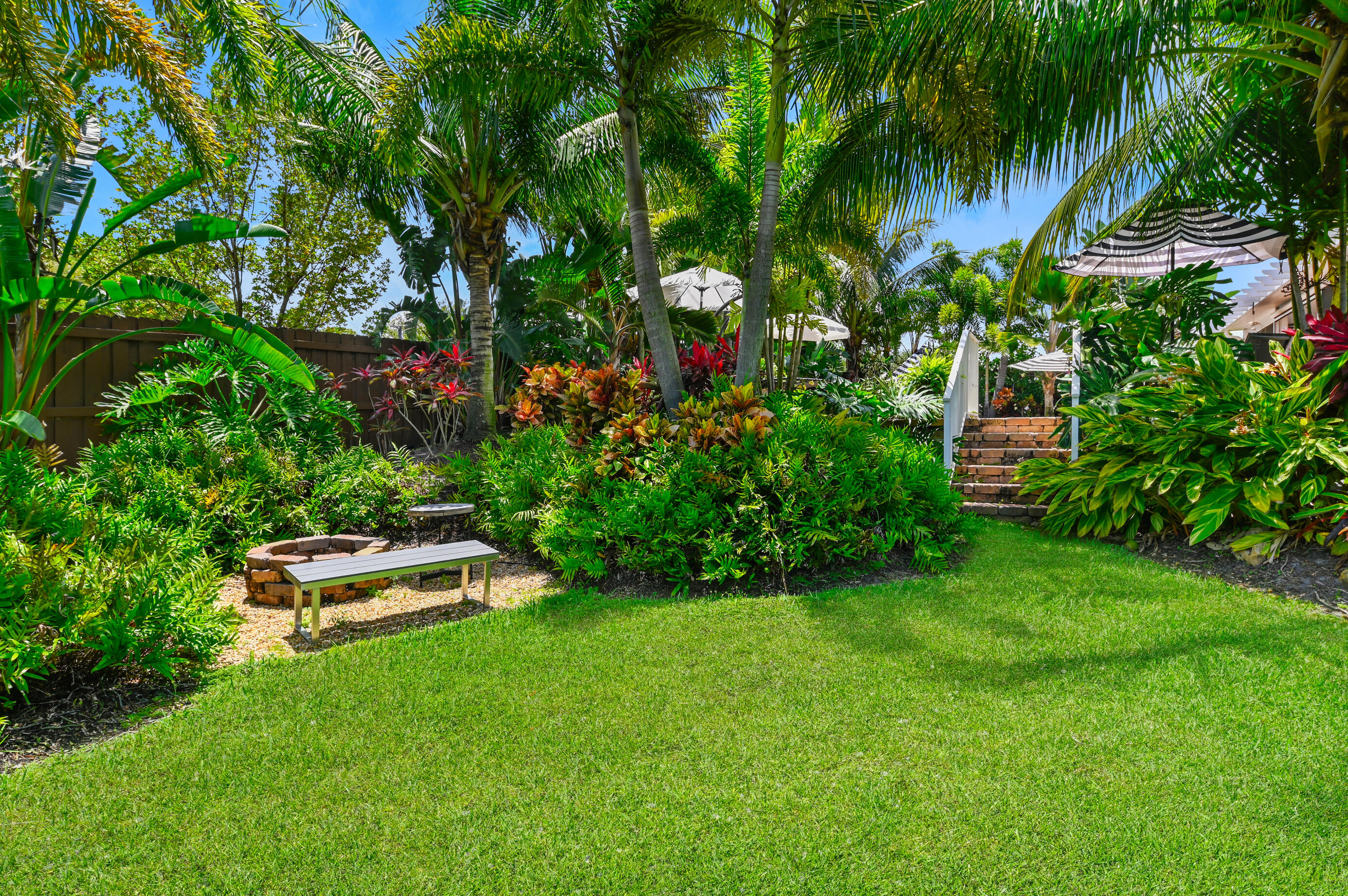 600 Mission Hill Road Boynton Beach, FL 33435 - Photo 38 of 42 a garden with trees in front of it