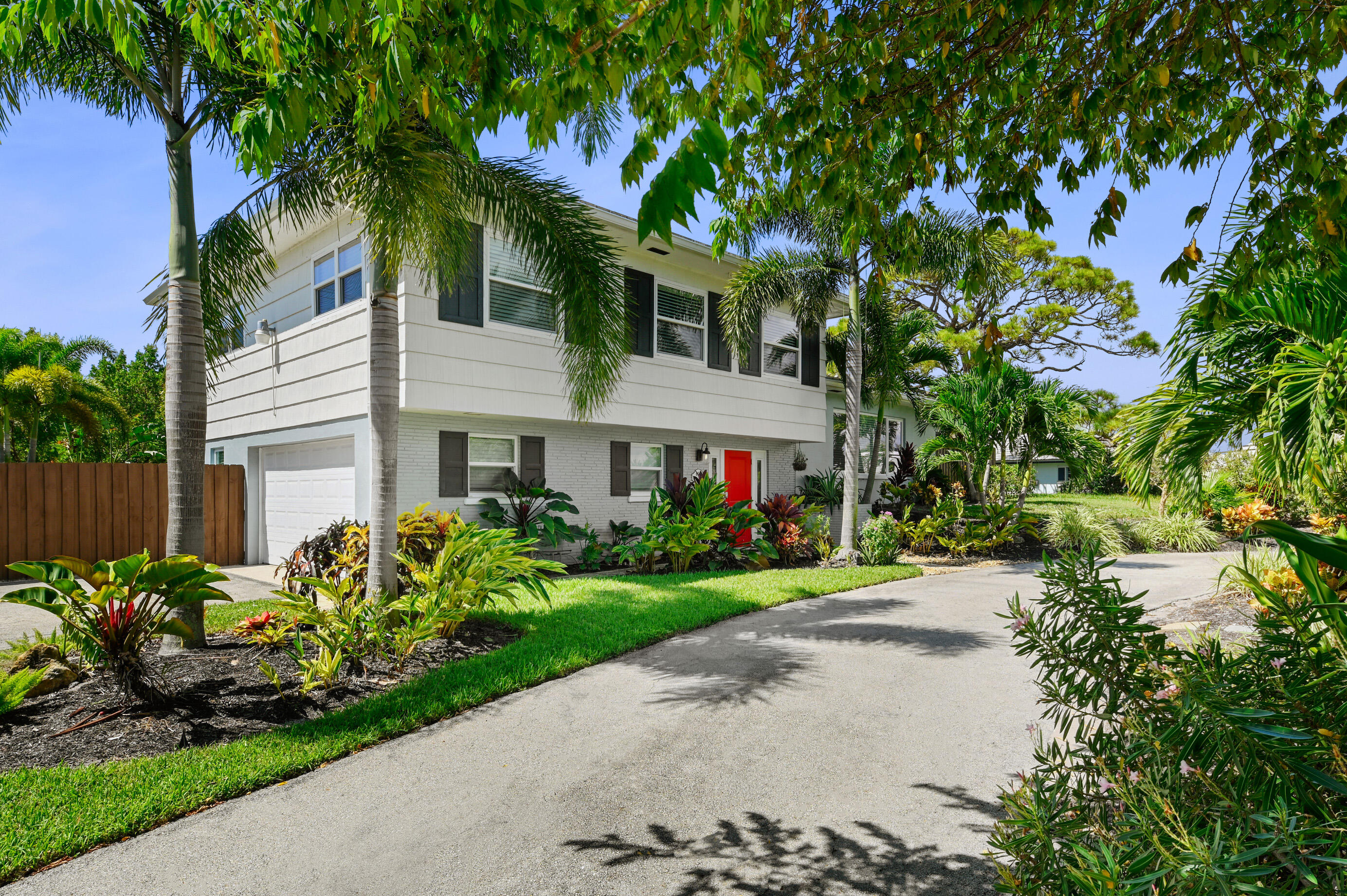 600 Mission Hill Road Boynton Beach, FL 33435 - Photo 4 of 42 a front view of a house with a yard and potted plants