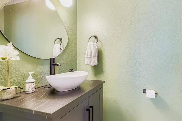 a kitchen with white cabinets and appliances