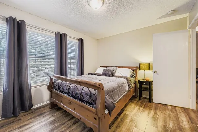 a spacious bedroom with a bed and a couch