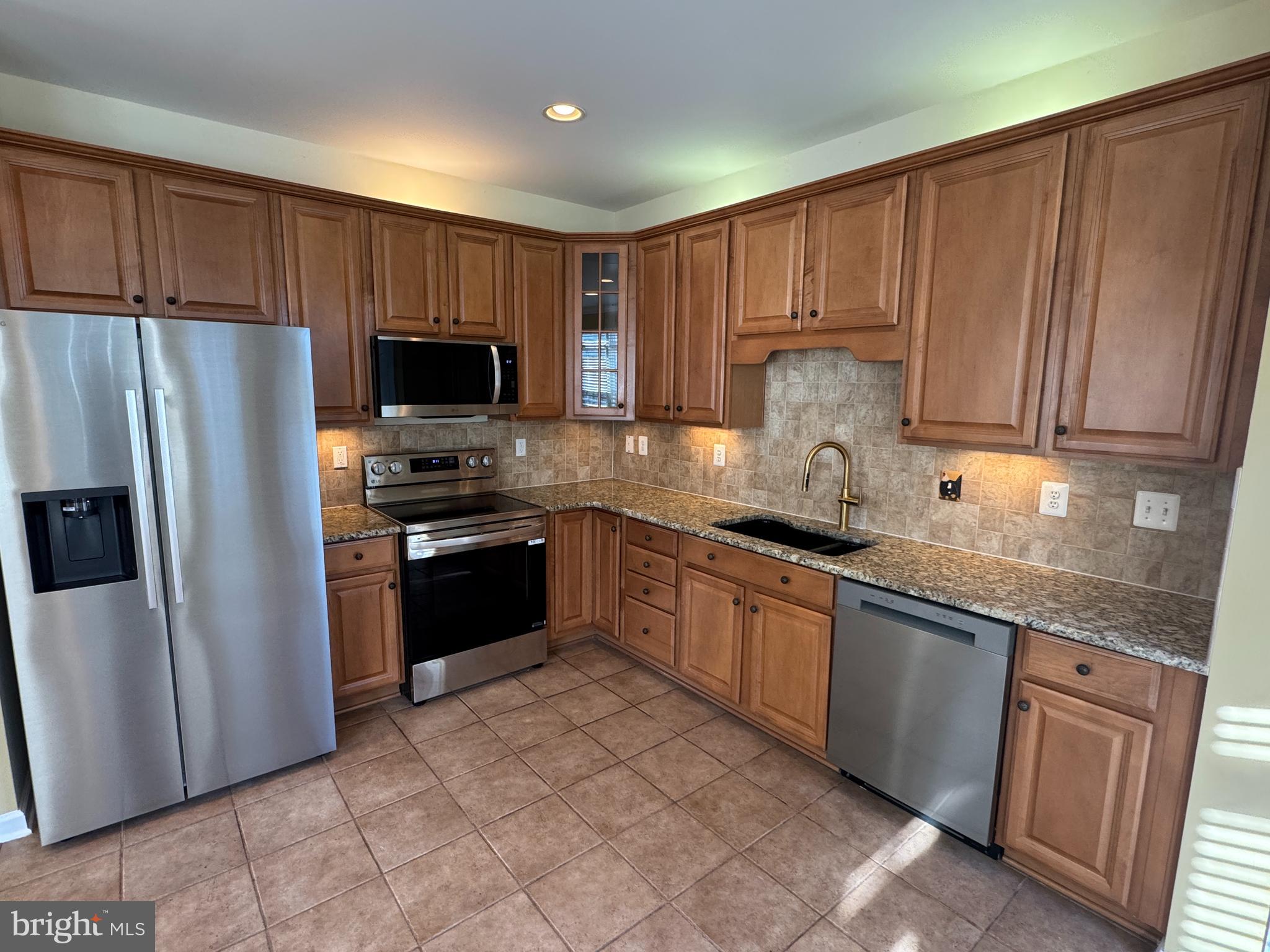 400 Kintyre Lane Stephens City, VA 22655 - Photo 11 of 33 a kitchen with granite countertop stainless steel appliances and wooden cabinets