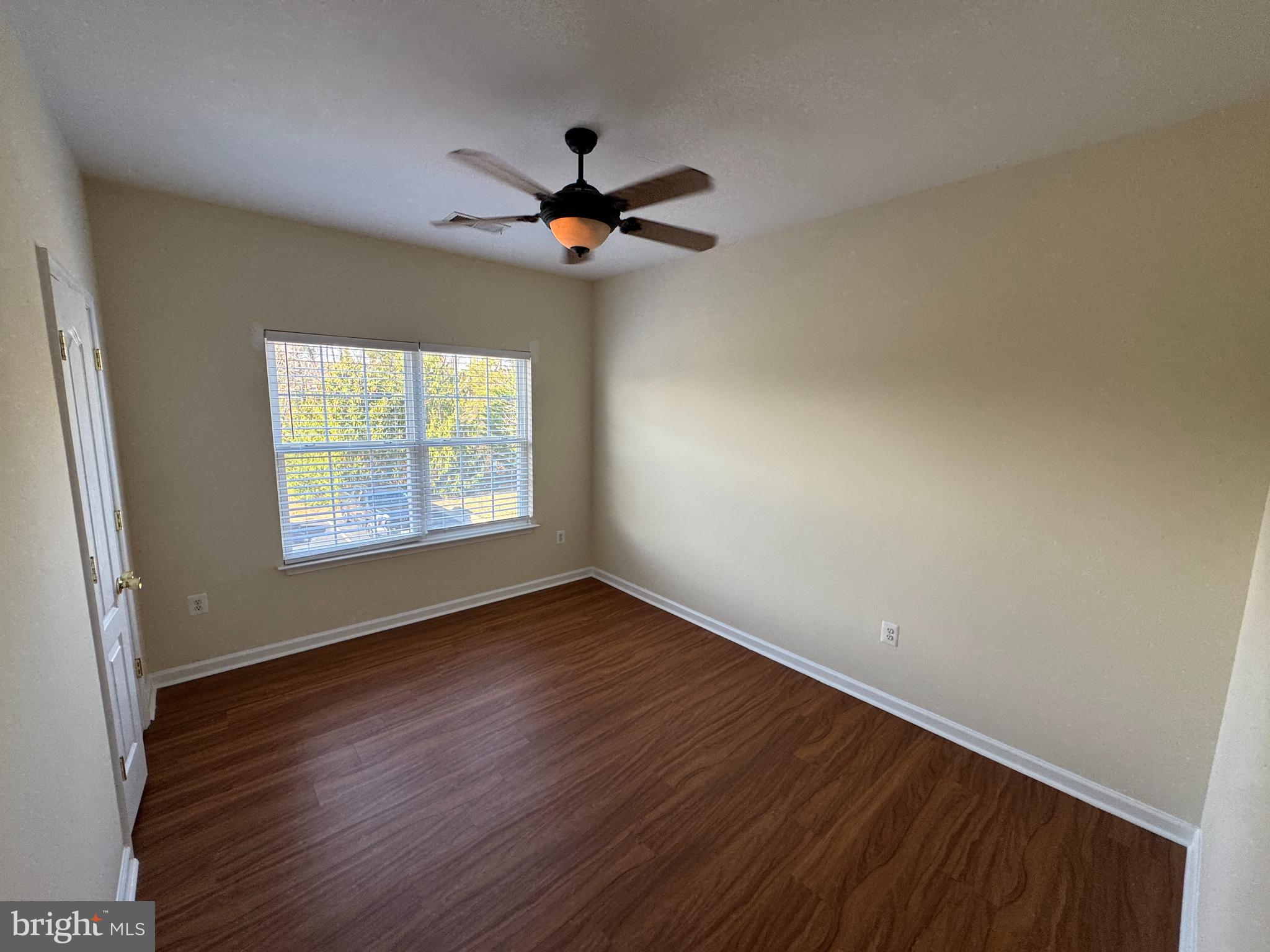 400 Kintyre Lane Stephens City, VA 22655 - Photo 16 of 33 an empty room with wooden floor fan and windows