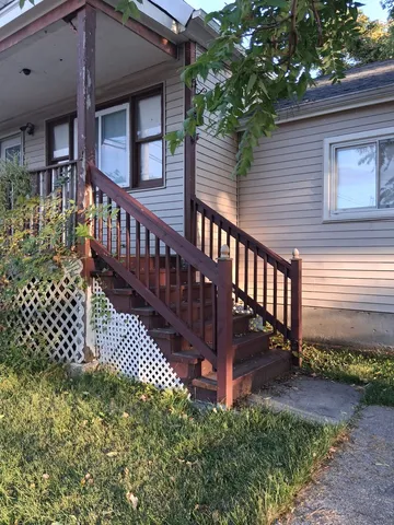 a view of a house with wooden fence