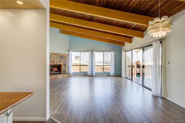 a view of a livingroom with wooden floor and a ceiling fan