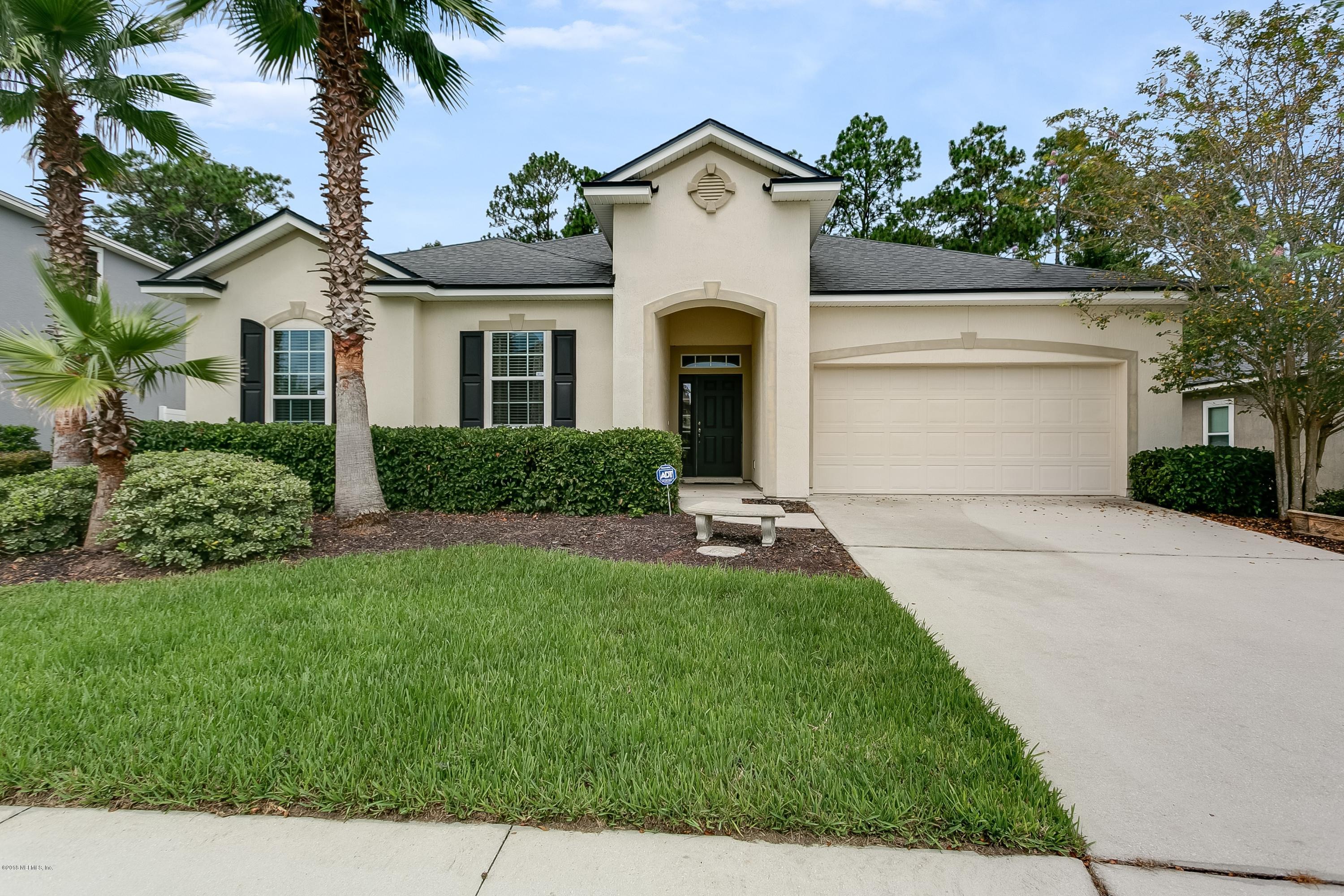 16378 Tisons Bluff Road Jacksonville, FL 32218 - Photo 1 of 24 a front view of a house with a yard and garage