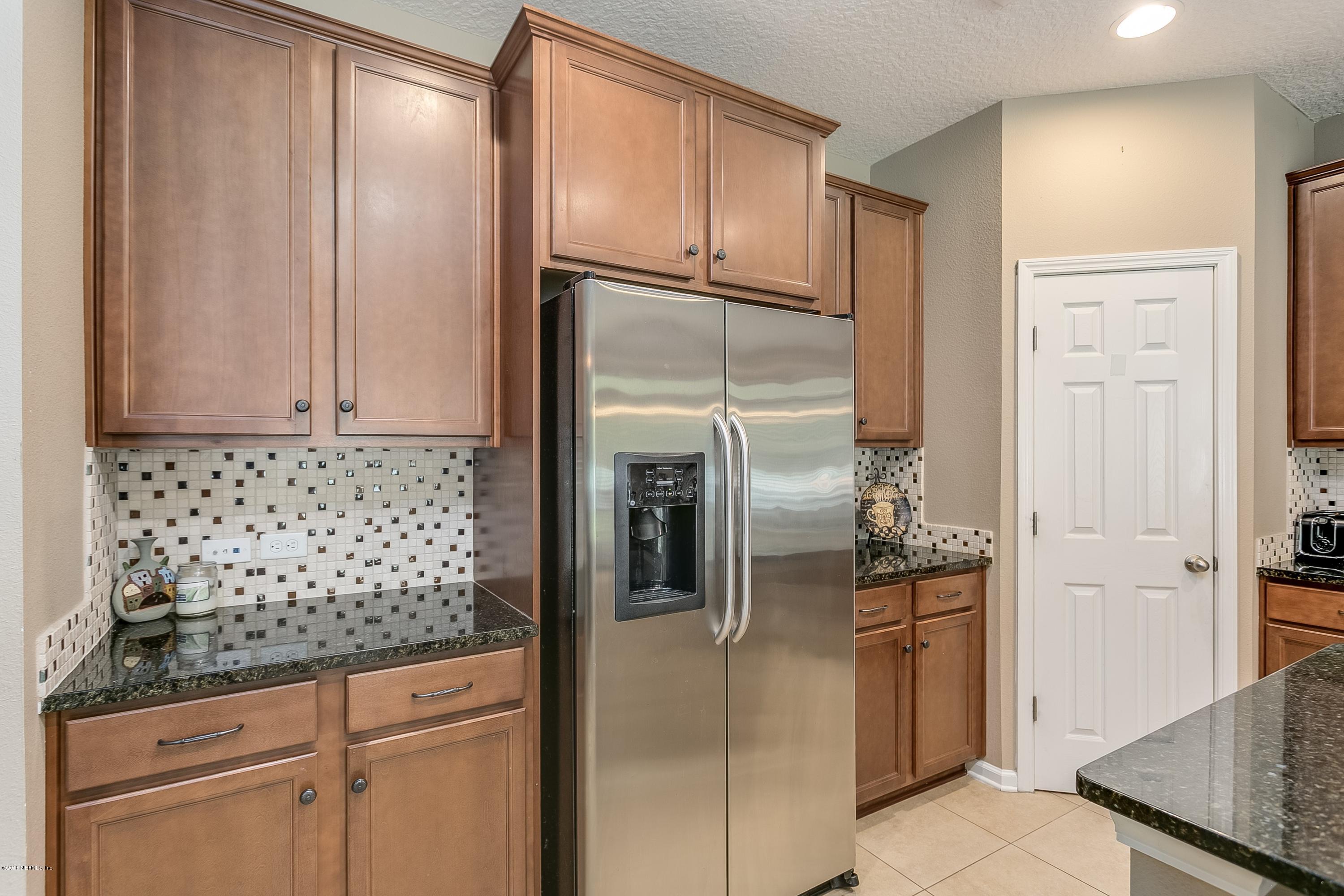 16378 Tisons Bluff Road Jacksonville, FL 32218 - Photo 11 of 24 a kitchen with stainless steel appliances granite countertop a refrigerator and a sink