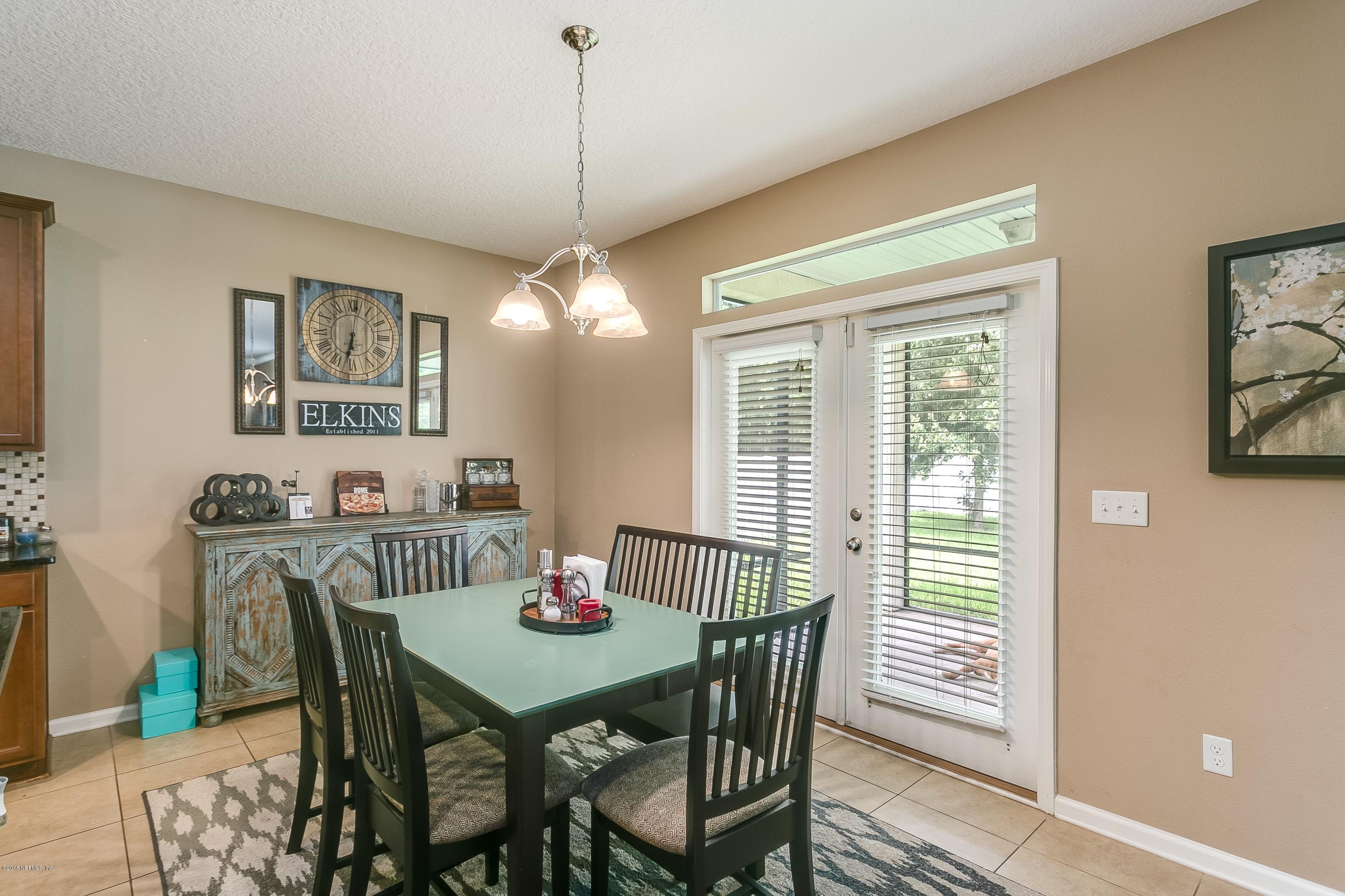 16378 Tisons Bluff Road Jacksonville, FL 32218 - Photo 12 of 24 a view of a dining room with furniture window and wooden floor