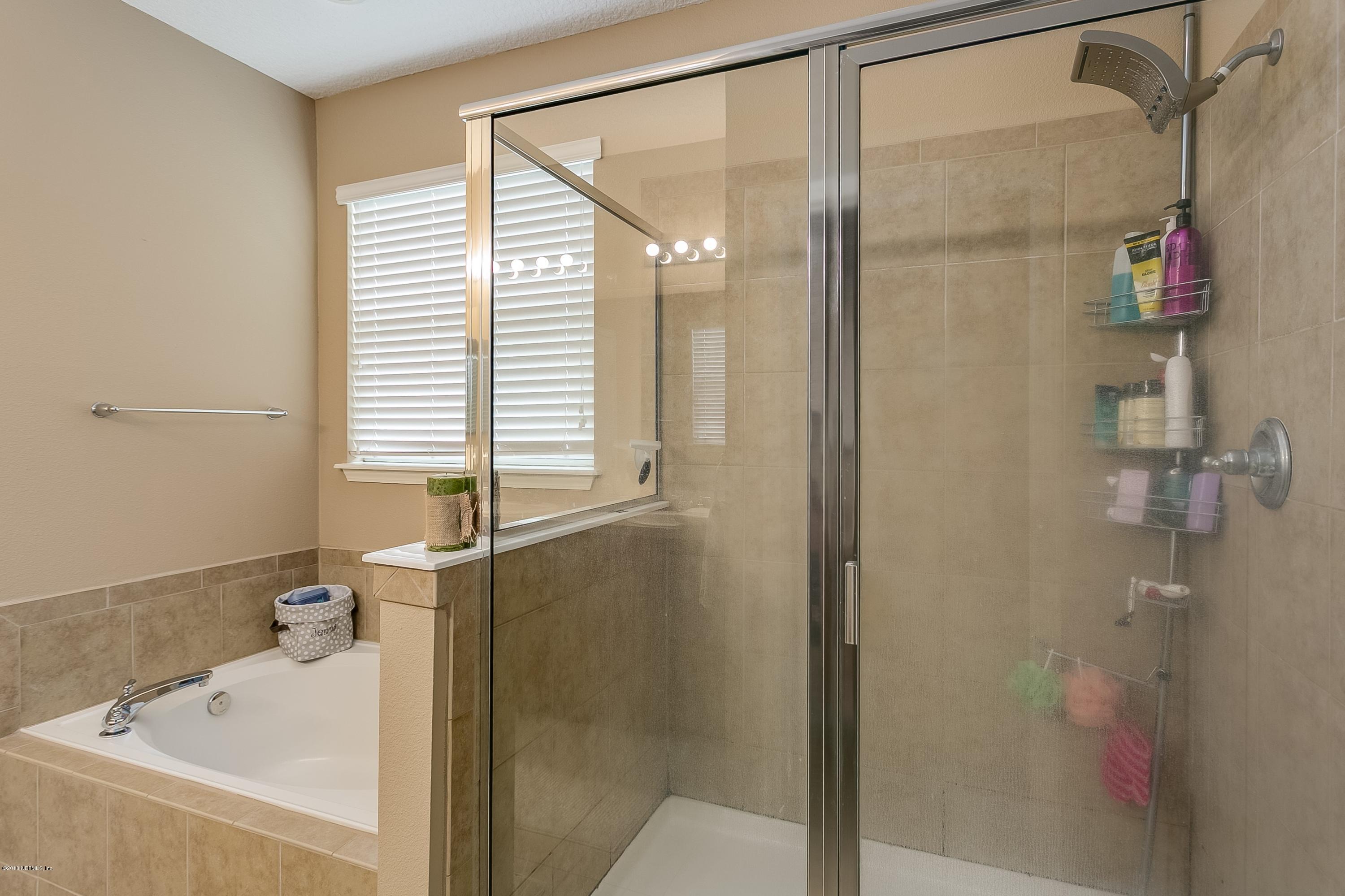 16378 Tisons Bluff Road Jacksonville, FL 32218 - Photo 16 of 24 a bathroom with a bathtub and a shower